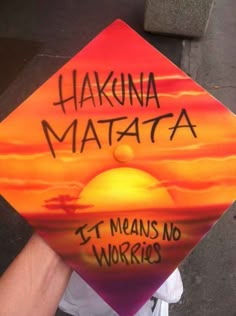 someone holding up a sign that says hakuna matata it means no works