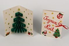 an origami christmas tree is next to a greeting card that says tokyo noel