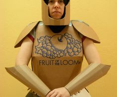 a man in a paper mache costume holding two baseball bats and wearing a helmet