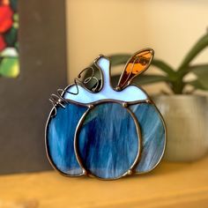 a glass pumpkin sitting on top of a wooden table