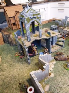 a game set up on the ground with lots of small buildings and figurines