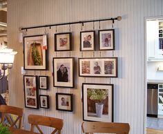 a dining room with pictures hanging on the wall