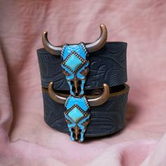 "These are one of our most popular bracelets we currently sell. Turquoise bull concho on a black embossed leather bracelet. It has 2 adjustable snap closures. The overall length of the bracelet is about 8.75\" long and it is 1\" wide. The adjustable snap closures are at about 7\" and 7.75\". To make sure this bracelet will fit you, measure the distance around your wrist. If you have any questions or need assistance don't hesitate to send us a message." Adjustable Western Cuff Bracelet For Festivals, Adjustable Western Style Cuff Bracelet For Festivals, Adjustable Western Leather Bracelet For Festivals, Adjustable Western Style Festival Cuff Bracelet, Western Style Adjustable Cuff Bracelet For Festivals, Adjustable Turquoise Leather Bracelet With Concho, Adjustable Western Cuff Bracelet With Patina, Adjustable Turquoise Cuff Bracelet With Concho, Western Style Turquoise Bracelet, Hand Tooled