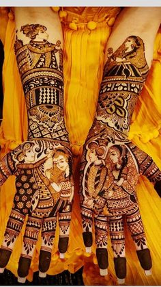 two hands painted with henna designs on them