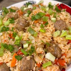 a white plate topped with rice and meat covered in vegtables on top of it