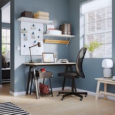 a room with a desk, chair and shelves on the wall next to a window