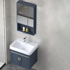 a bathroom sink sitting under a mirror next to a wall mounted cabinet