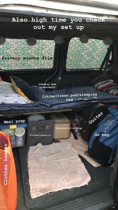 the back end of a van with luggage and other items in it's trunk