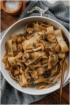 a white bowl filled with pasta and mushrooms