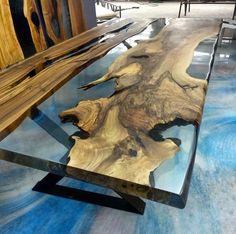 a table made out of wood and glass in a room with wooden benches behind it