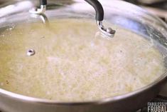 a pan filled with liquid sitting on top of a stove