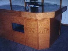 an aquarium in a wooden cabinet with glass doors