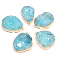 four pieces of blue druzzled glass with gold accents