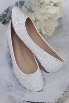 white wedding shoes with flowers on the side