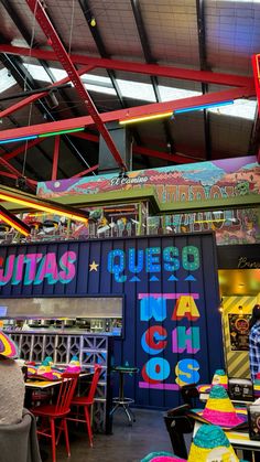 the interior of a restaurant with colorful walls and ceiling decorations on it's sides