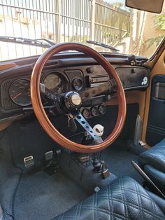 the interior of an old car with wood trim and gauges on it's dashboard