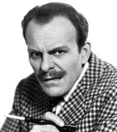 black and white photograph of a man holding a coffee cup in his right hand while looking at the camera