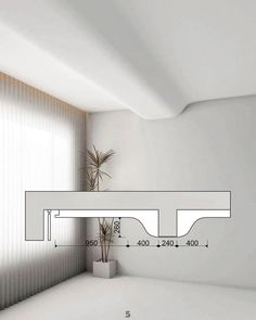 a white room with a plant in the corner and measurements on the wall above it