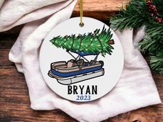 a personalized ornament with a boat and christmas tree