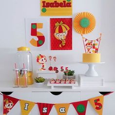 a table topped with cake and cupcakes on top of a white countertop