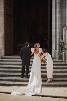 the bride and groom are getting ready to walk down the stairs