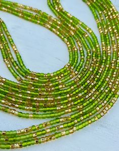 Description One 50 inch tie-on luxury waist bead Created on a durable Ghanian string A blend of green and gold seed beads Traditional Green Multi-strand Beads, Green Beaded Bracelet With Gold Beads, Adjustable Gold Oval Waist Beads, Bohemian Green Waist Beads With Colorful Beads, Multi-strand Green Faceted Beads, Bohemian Green Waist Beads, Elegant Gold Waist Beads With Colorful Beads, Elegant Gold Waist Beads With Colorful Details, Elegant Gold Waist Beads With Tiny Beads