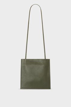 A khaki mini crossbody bag with a slim pouch design. It features a thin adjustable leather strap that can transition as a shoulder bag. Halo Collection, Minimalistic Aesthetic, Bag Aesthetic, Bags Aesthetic, Bag Collection, Pocket Bag, Purse Bag, Crossbody Purse, Sling Bag