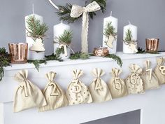 a mantle decorated with christmas stockings and candles