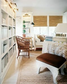 a living room filled with furniture and bookshelves