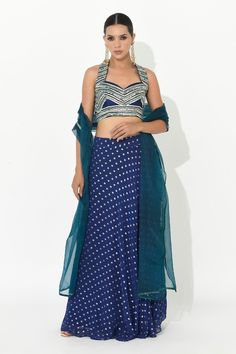 Electric blue skirt with contrasting polka dot patterns. Comes with mirror embroidered halter neck blouse and dupatta. - Aza Fashions Layered Lehenga, Halter Neck Blouse, Halter Neck Blouses, Sangeet Outfit, Mehendi Outfits, Dot Patterns, Embellished Skirt, Organza Flowers, Hem Skirt