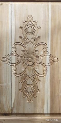 an intricately carved wooden door with wood paneling