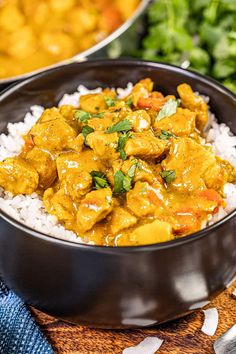 two bowls filled with rice and chicken curry