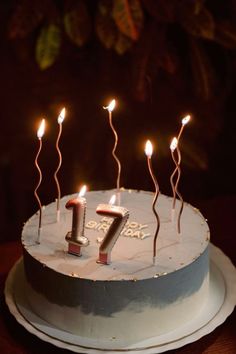 a birthday cake with candles in the shape of number seven