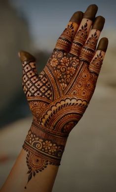 the hand is decorated with henna on it