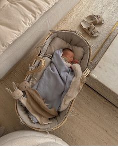 a baby is sleeping in a bag on the floor