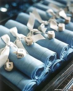 several folded blue cloths with white bows on them are sitting in a row and ready to be sewn