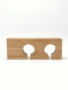 a wooden object with two holes in the middle