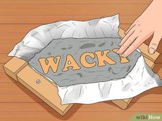 an open box with the word wack in it and someone's hand on top