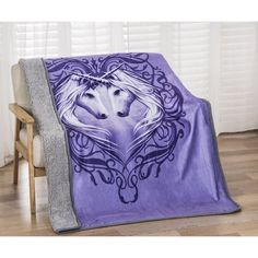 a purple blanket with an image of a wolf in the middle and a heart on it