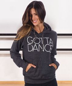 a woman wearing a sweatshirt with the words gota dance on it