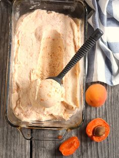 a glass dish filled with ice cream next to sliced apricots