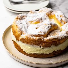 a cake sitting on top of a plate covered in powdered sugar and icing