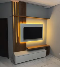 a flat screen tv mounted to the side of a wall in a room with tile flooring