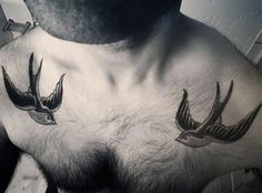 a man's chest with three birds on it and one bird flying in the air