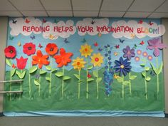 a bulletin board with paper flowers and butterflies on it that says reading helps your information bloom