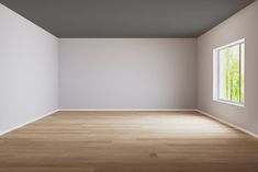 an empty room with white walls and wood floors