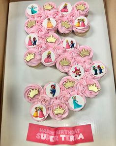 cupcakes decorated with pink frosting and princess images