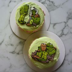 two cupcakes with green frosting decorated as the teenage mutant characters on them