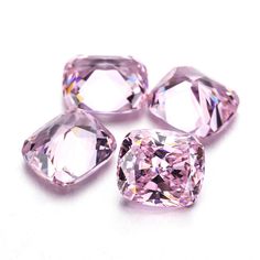 three pink diamonds on a white surface