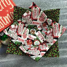 a pile of candy sitting on top of a table next to a christmas card box